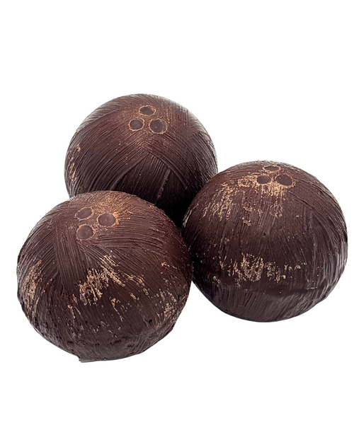 Three dark brown chocolate coconuts on a white background
