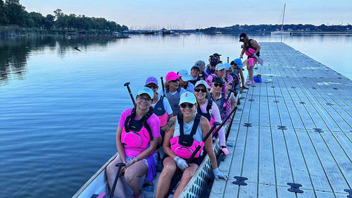 Rowers on a dock preparing for a rowing session