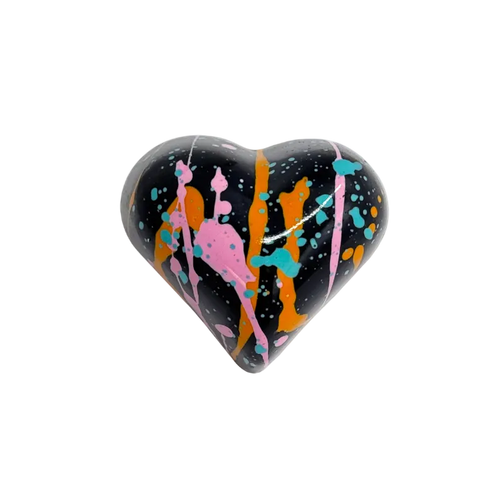 Heart-shaped bonbon with colorful abstract design on a white background