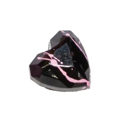Heart-shaped black gemstone bonbon with pink accents on a white background