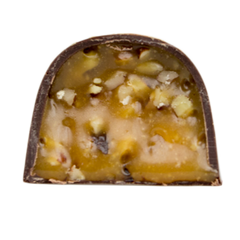 Chocolate bonbon cut in half filled with caramel and pecans