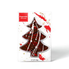 Chocolate tree-shaped candy with white drizzle, in a white decorative box, titled 'Peppermint tree bark'.