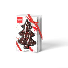 Chocolate tree-shaped candy in a decorative box with a red ribbon on a white background