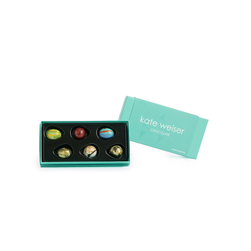 Box of assorted chocolates with a teal color on a white background